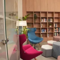 View from the door, view of tables, chairs and bookcase