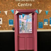 View from outside the room with sign reading 'The Resource Centre'