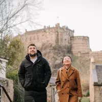 Students walking in Edinburgh with views of Edinburgh Castle 