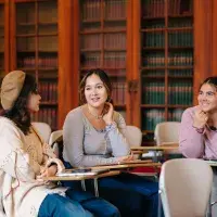 Three students in a classroom 