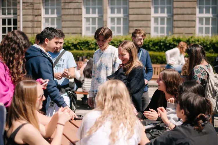 Students sitting outside in the Holyrood Campus quad