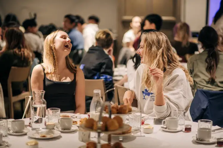 Students laughing at afternoon tea