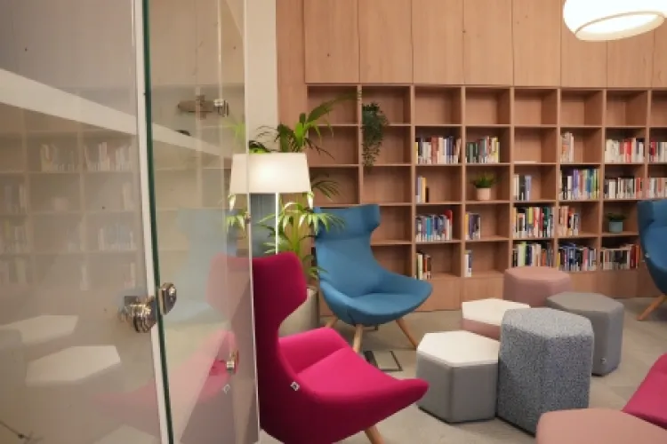 View from the door, view of tables, chairs and bookcase