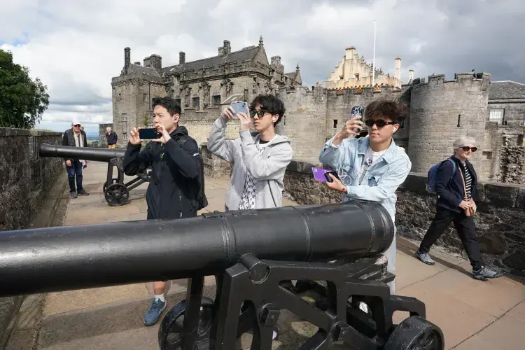Three students standing beside the canon at Stirling Castle