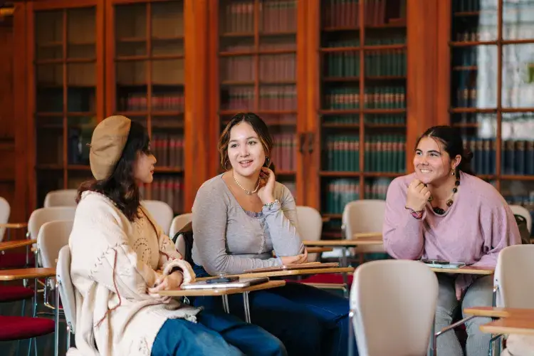 Three students in a classroom 