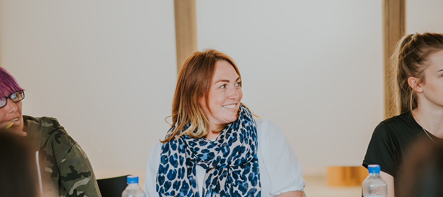 Female student smiles off camera
